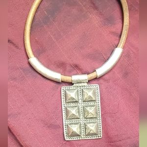 Statement Necklace Silver metal hung on leather .